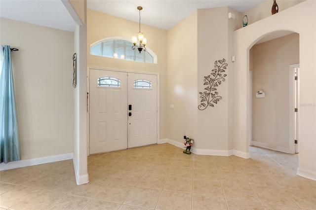 entrance foyer featuring a chandelier and light tile patterned floors