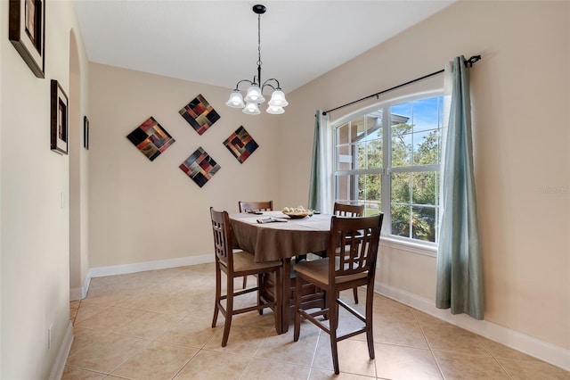 dining room with an inviting chandelier, a healthy amount of sunlight, and light tile patterned floors