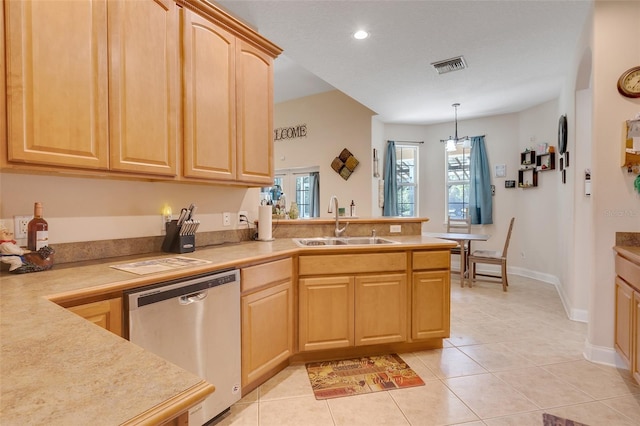 kitchen featuring dishwasher, sink, decorative light fixtures, light tile patterned floors, and light brown cabinetry