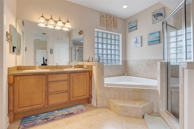 bathroom with vanity, shower with separate bathtub, a healthy amount of sunlight, and tile patterned flooring