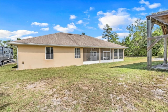 back of house with a sunroom and a lawn