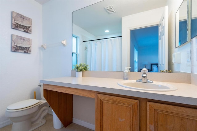 bathroom featuring tile patterned floors, vanity, toilet, and curtained shower