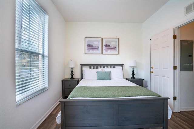 bedroom with dark hardwood / wood-style floors