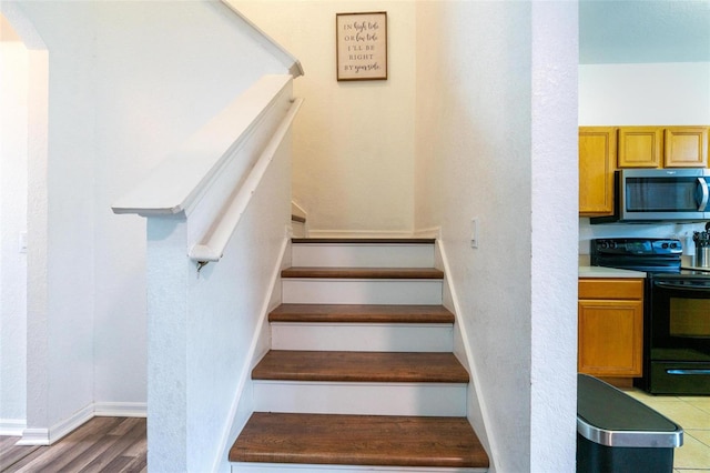 staircase featuring hardwood / wood-style floors