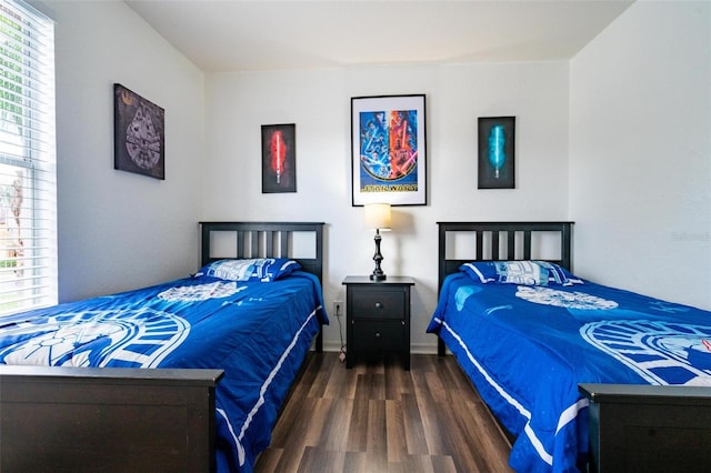 bedroom featuring dark hardwood / wood-style flooring and multiple windows