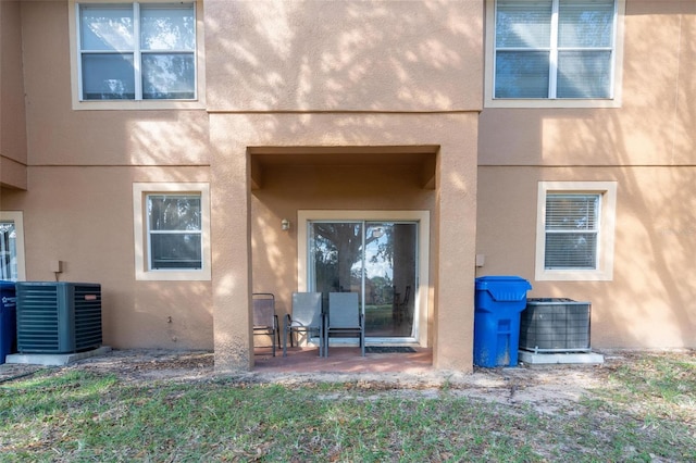 rear view of house with a patio and cooling unit