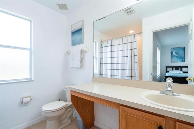 bathroom with tile patterned floors, curtained shower, vanity, and toilet