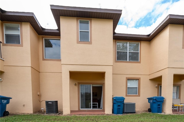 back of property featuring central AC