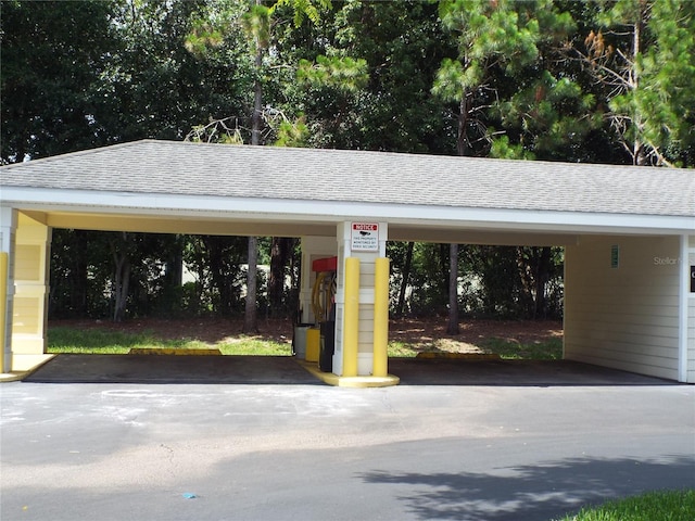 view of parking / parking lot featuring a carport