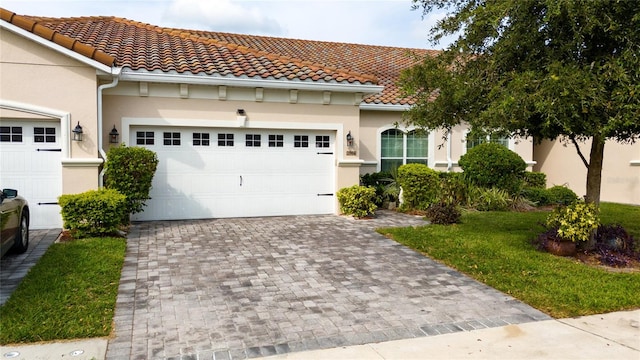 mediterranean / spanish house with a garage