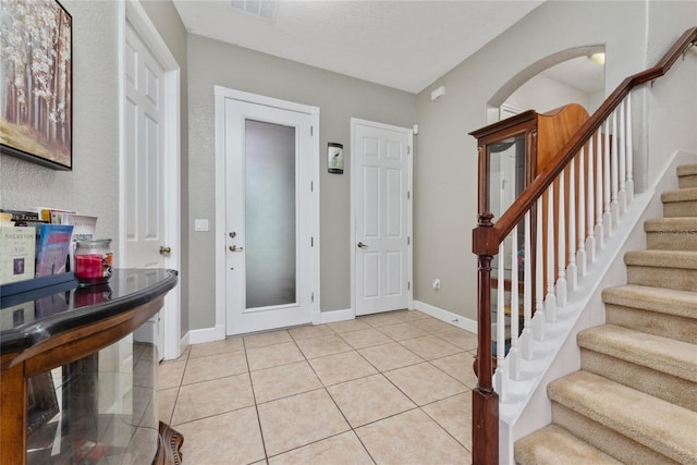 entrance foyer featuring a textured ceiling and light tile patterned floors