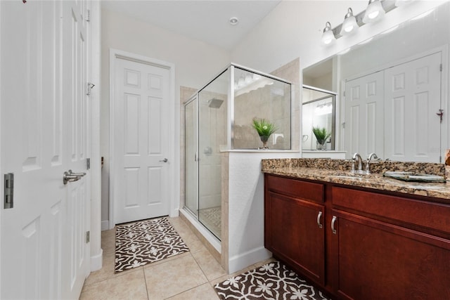 bathroom with vanity, an enclosed shower, and tile patterned floors