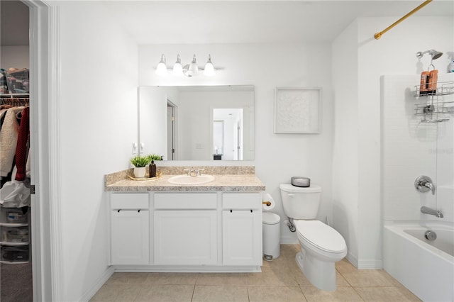 full bathroom featuring vanity, toilet, tile patterned floors, and washtub / shower combination