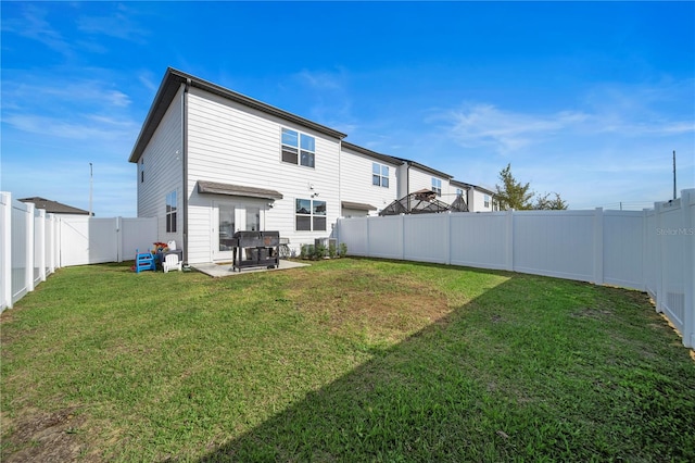 back of property featuring a patio area and a lawn