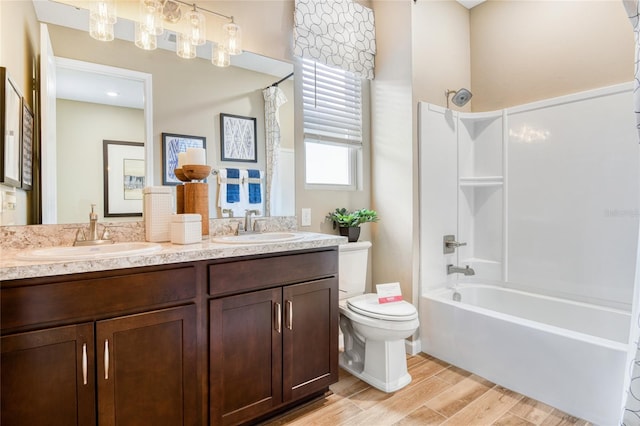 full bathroom with vanity, toilet, wood-type flooring, and shower / washtub combination