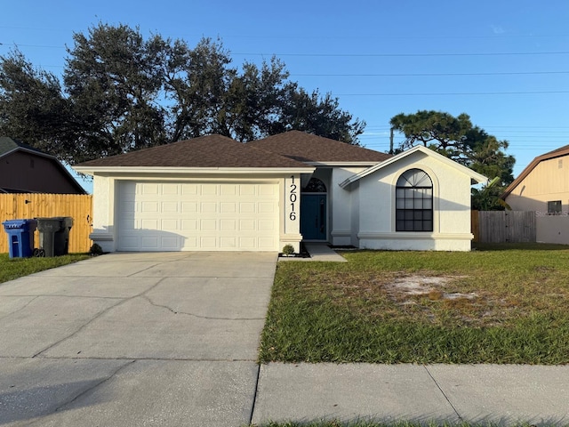 ranch-style house featuring a garage and a front lawn