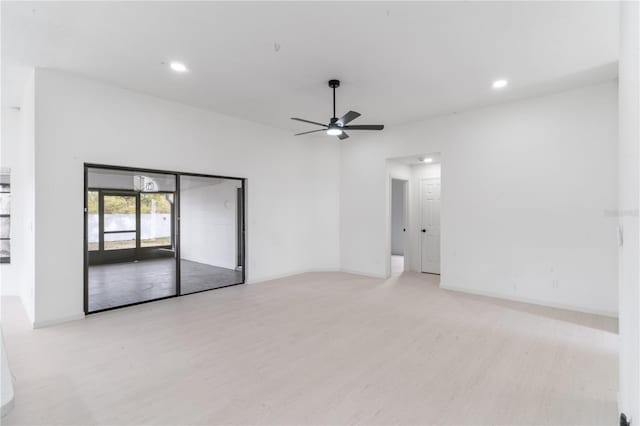 spare room with light wood-type flooring and ceiling fan