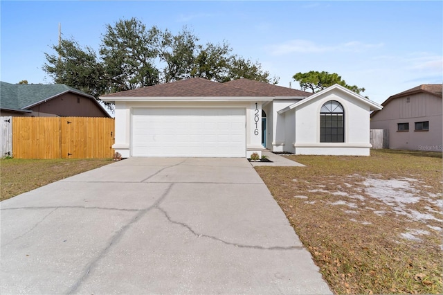 ranch-style home with a garage and a front lawn