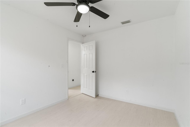 empty room featuring ceiling fan and light hardwood / wood-style floors