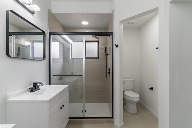 bathroom featuring vanity, toilet, and walk in shower