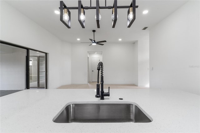 details featuring light stone countertops and sink