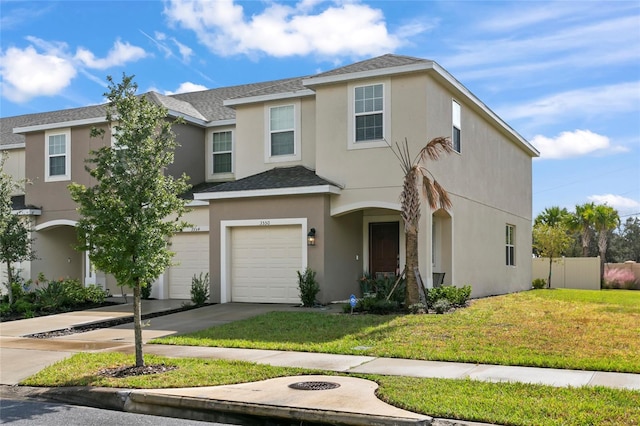 view of front of house featuring a garage and a front lawn