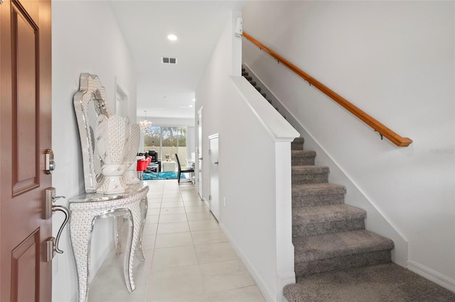 interior space with a chandelier and tile patterned floors