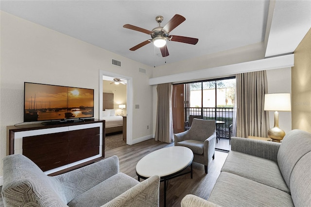 living room with ceiling fan and hardwood / wood-style flooring