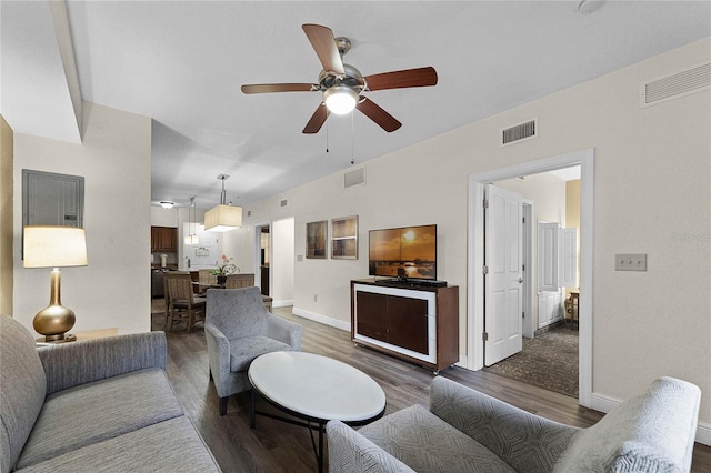 living room featuring ceiling fan and dark hardwood / wood-style flooring