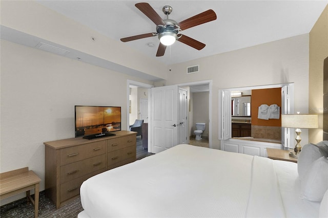 12527 Floridays Resort Dr Unit E-103, Orlando, FL 32821 - bedroom with connected bathroom and ceiling fan