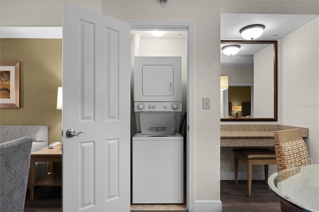 12527 Floridays Resort Dr Unit E-103, Orlando, FL 32821 - washroom featuring stacked washing machine and dryer and wood finished floors
