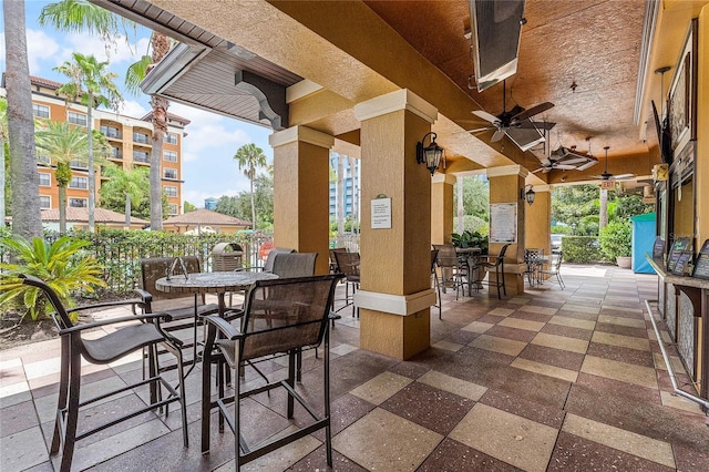 12527 Floridays Resort Dr Unit E-103, Orlando, FL 32821 - view of patio featuring outdoor dining space and a ceiling fan