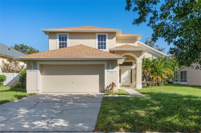 view of front of property featuring a front yard and a garage