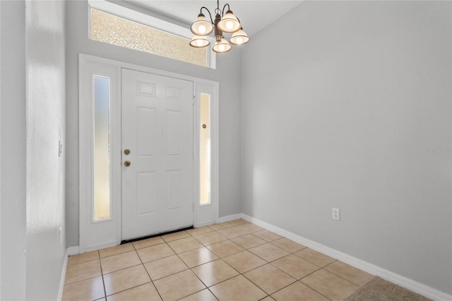 foyer entrance featuring a notable chandelier and light tile patterned flooring