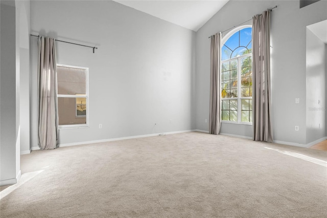 carpeted empty room featuring vaulted ceiling