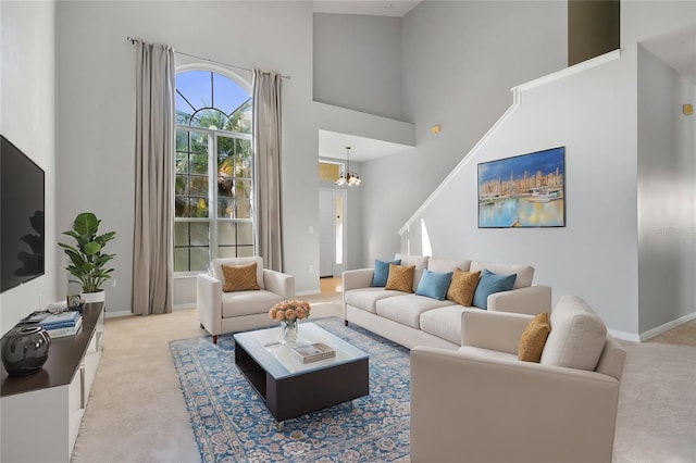 carpeted living room with a notable chandelier and a towering ceiling