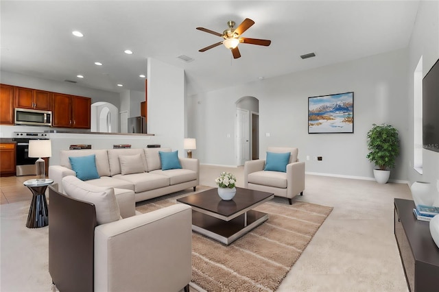 living room with light colored carpet and ceiling fan