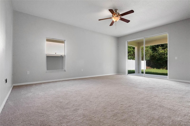 carpeted empty room with a textured ceiling and ceiling fan