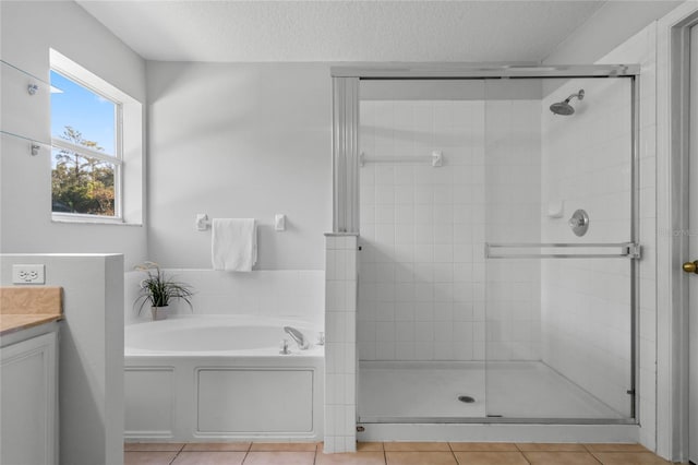 bathroom with vanity, independent shower and bath, a textured ceiling, and tile patterned floors