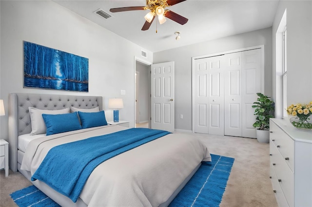 carpeted bedroom with a closet and ceiling fan