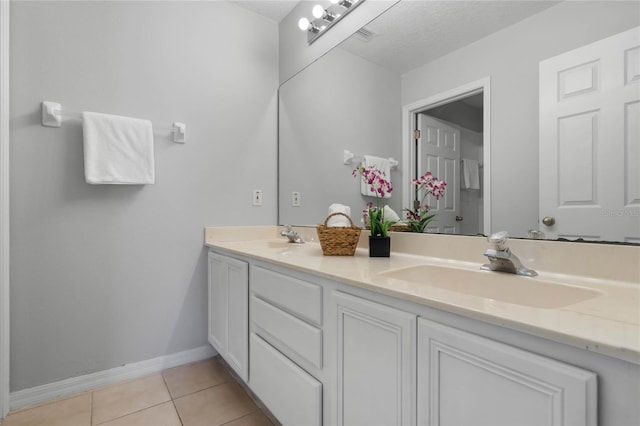 bathroom with vanity, tile patterned floors, and a textured ceiling