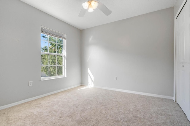 empty room with light carpet and ceiling fan