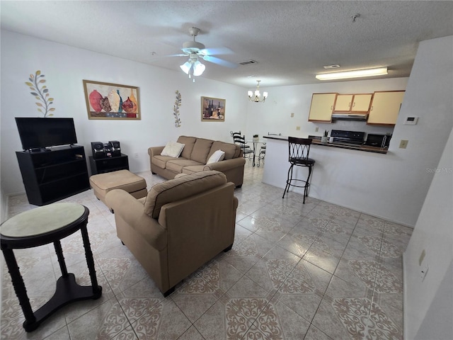 623 Dory Ln Unit 112, Altamonte Springs, FL 32714 - living room featuring ceiling fan, a chandelier, light tile patterned floors, and a textured ceiling