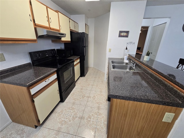 kitchen featuring sink, black appliances, light tile patterned flooring, and dark stone counters