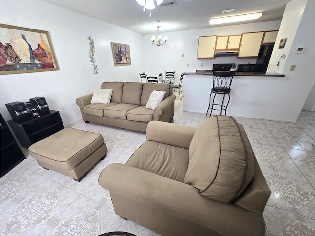 tiled living room featuring a notable chandelier