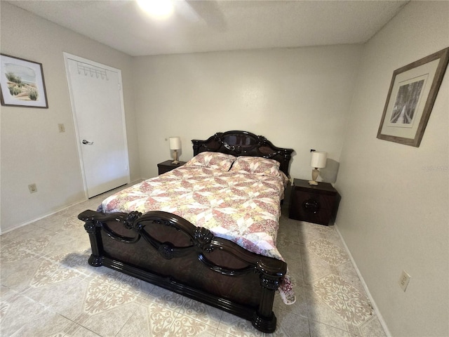 bedroom featuring light tile patterned flooring and ceiling fan