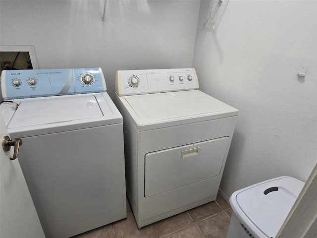 laundry area featuring light tile patterned flooring and washer and clothes dryer