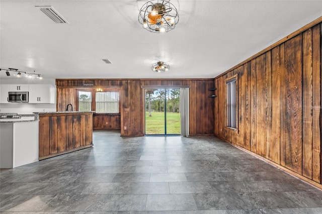 965 Keen Rd, Frostproof, FL 33843 - unfurnished living room with wooden walls and a textured ceiling