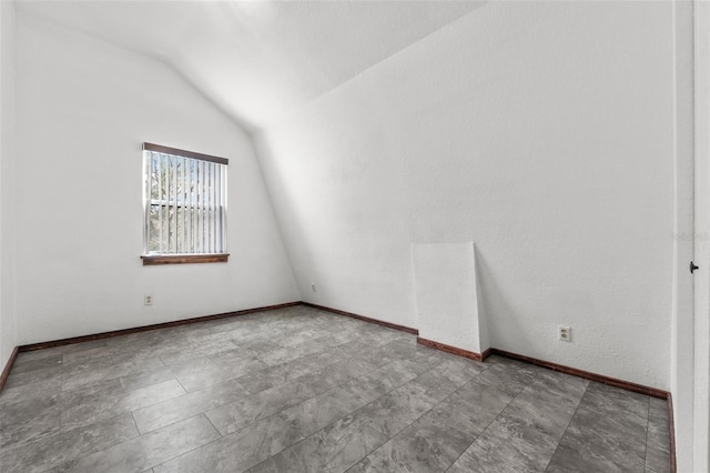 unfurnished room with lofted ceiling