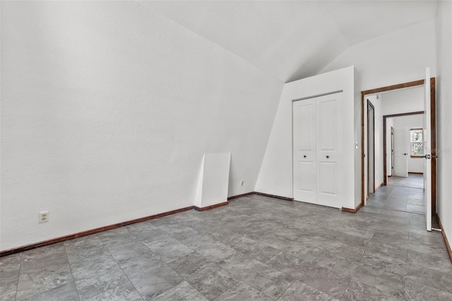 spare room with lofted ceiling